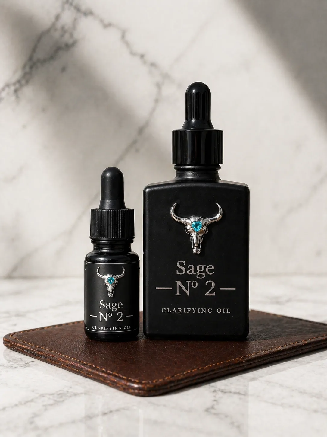 Sage Nº 2 30 mL Collector and 10 mL Discovery bottles side by side on white marble