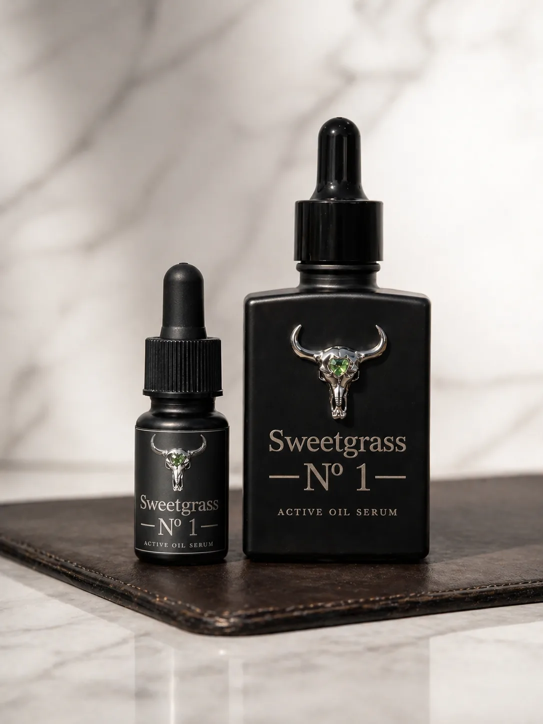 Sweetgrass Nº 1 30 mL Collector and 10 mL Discovery bottles side by side on white marble